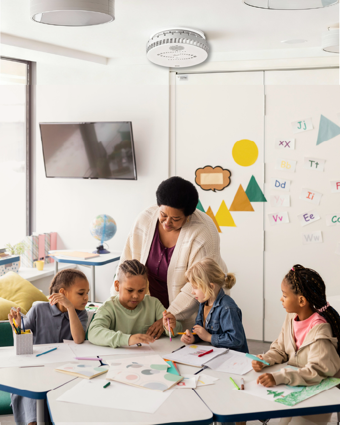 Teacher and students are in the classroom under the watchful eye of the Halo Smart Sensor
